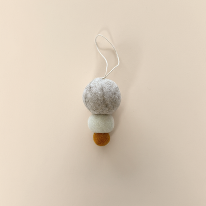 Pebble Studio felt Christmas decoration on a beige background