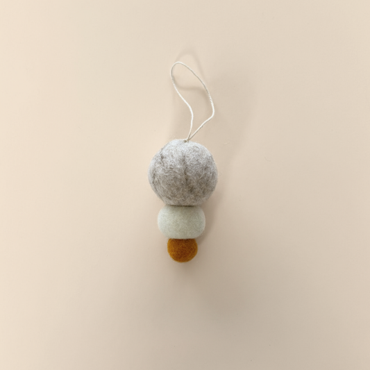 Pebble Studio felt Christmas decoration on a beige background