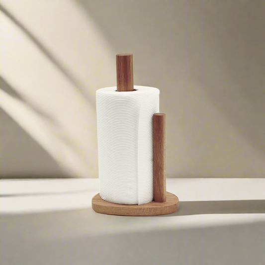Wooden paper towel holder with a roll of white paper towels on a neutral background