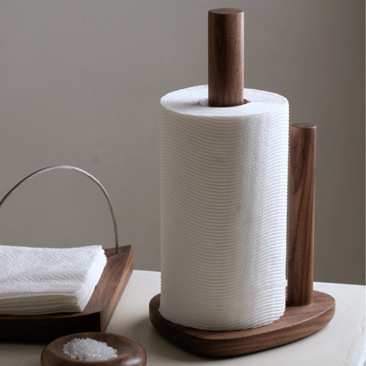 Wooden paper towel holder with a roll of paper towels on a neutral background