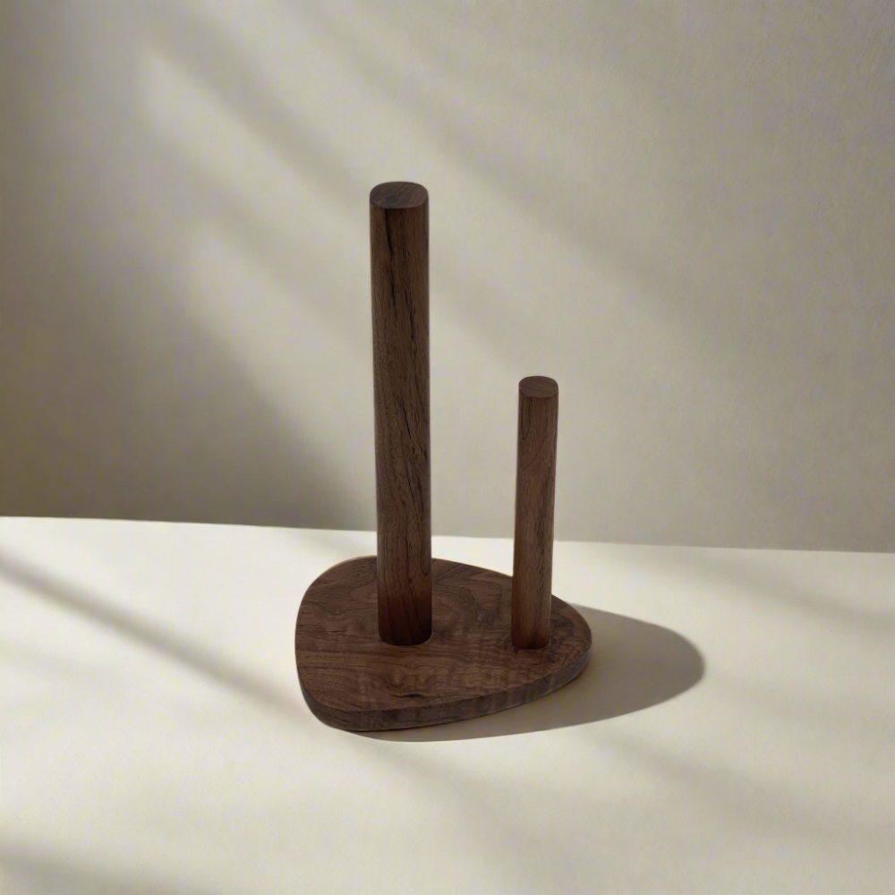 Wooden paper towel holder on a white surface with a neutral background