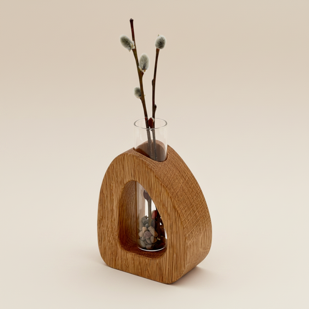 Wooden vase with a clear glass insert holding willow branches on a beige background