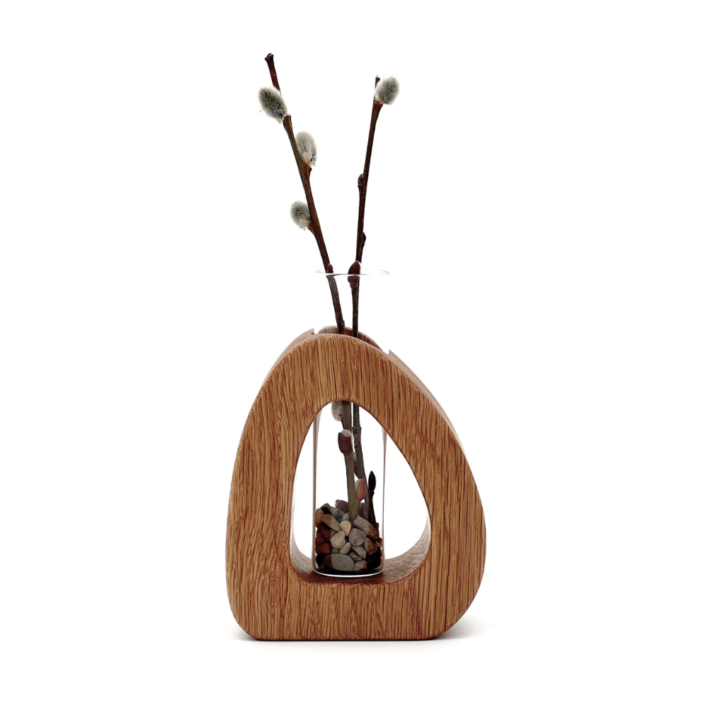 Wooden vase with willow branches on a white background