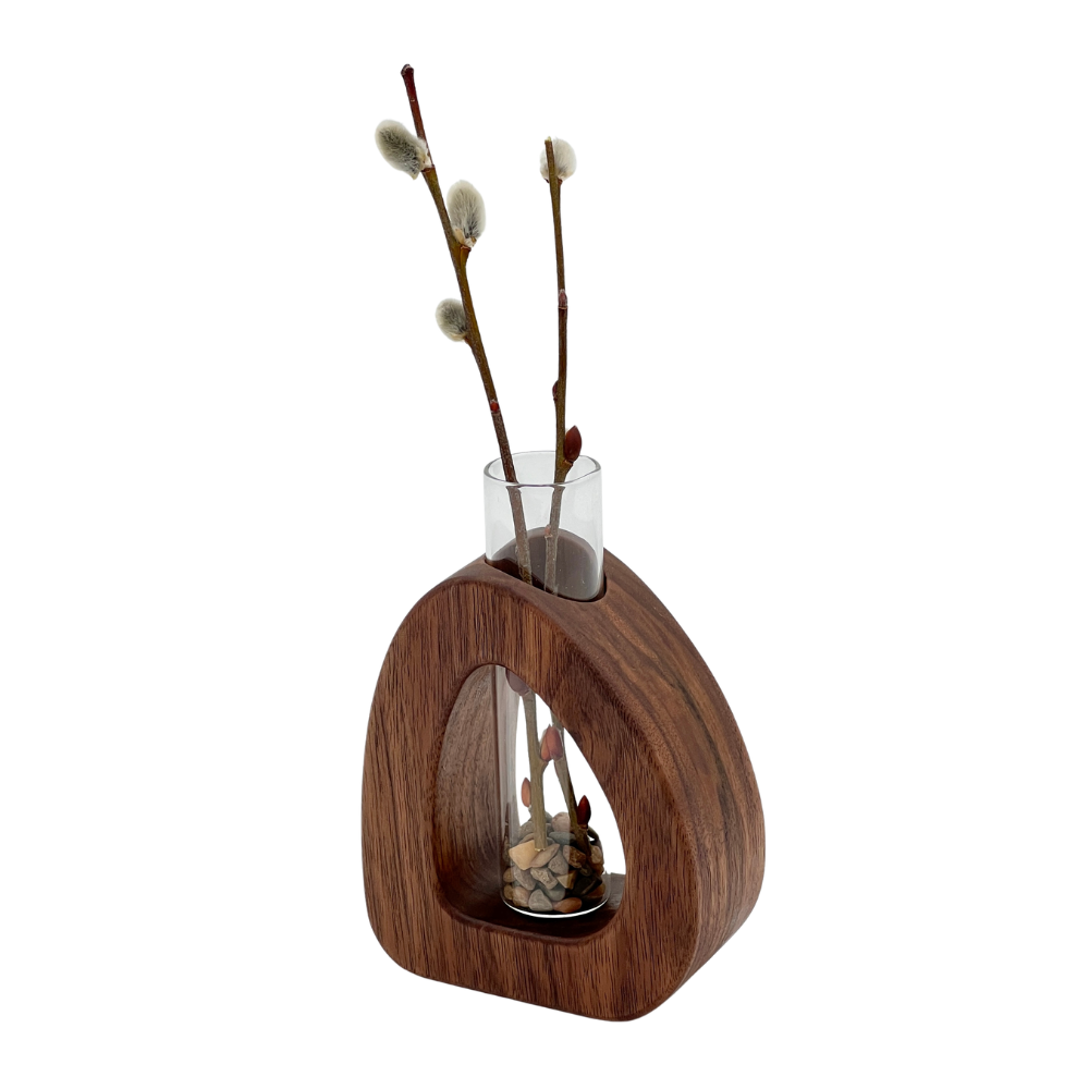 Wooden vase with glass insert and willow branches on a white background