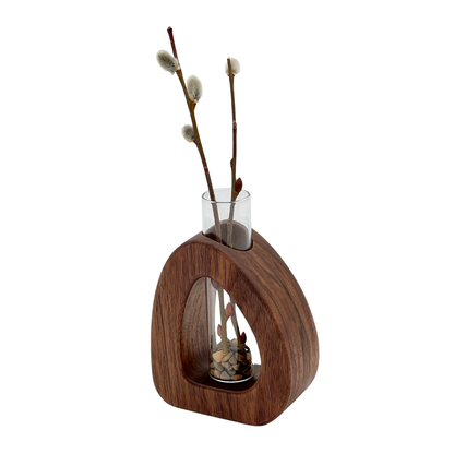 Wooden vase with glass insert and willow branches on a white background