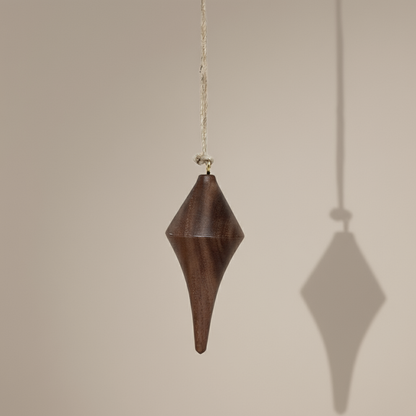 Hand turned walnut timber ornament with jute loop. Pebble Studio sustainable Christmas decor