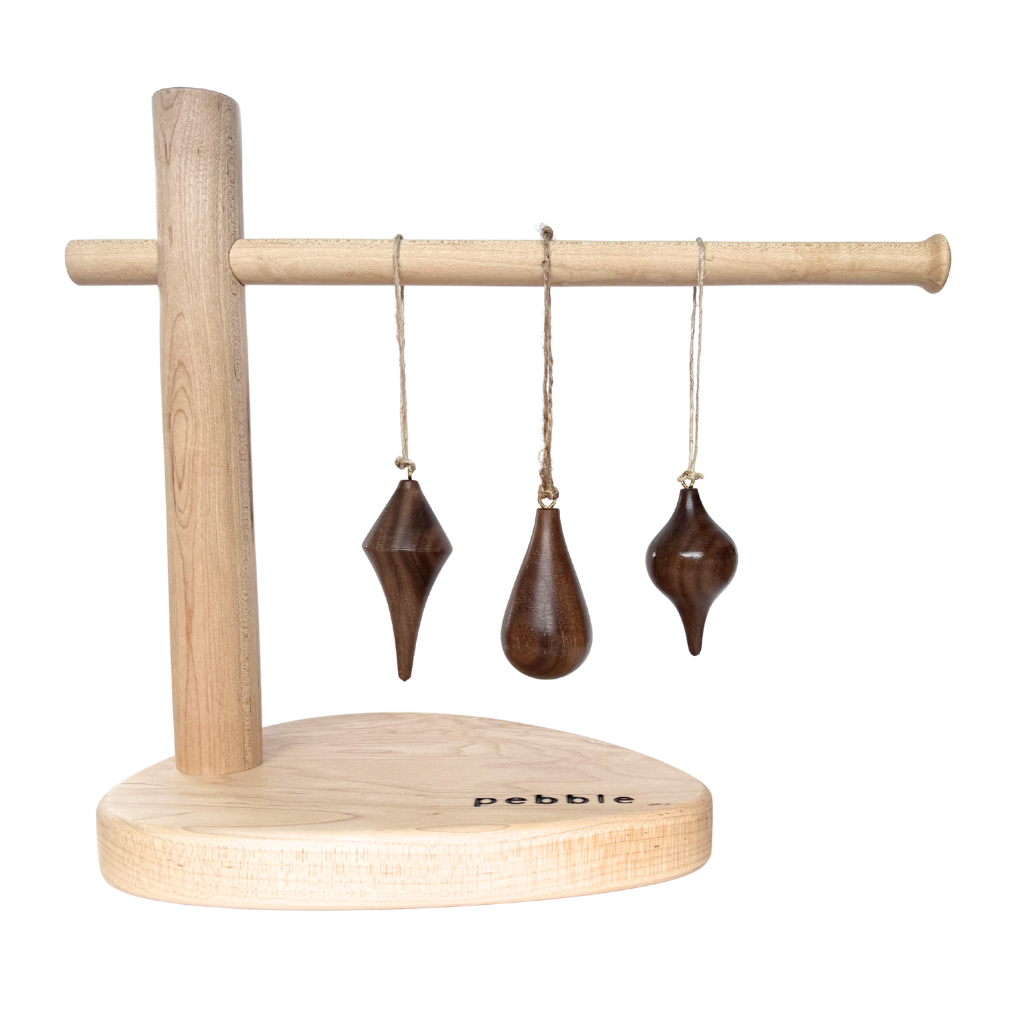 Hand turned walnut timber ornaments in organic icicle shapes with jute loop. Pebble Studio sustainable Christmas decor