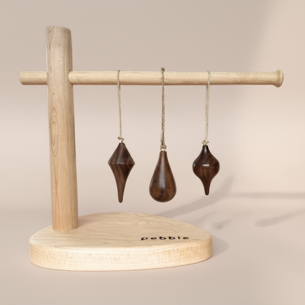 Hand turned walnut timber ornaments in organic icicle shapes with jute loop. Pebble Studio sustainable Christmas decor