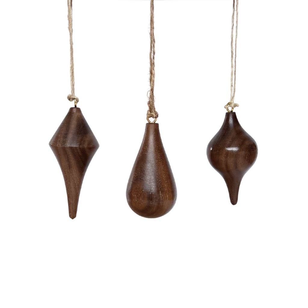 Hand turned walnut timber ornaments in organic icicle shapes with jute loop. Pebble Studio sustainable Christmas decor