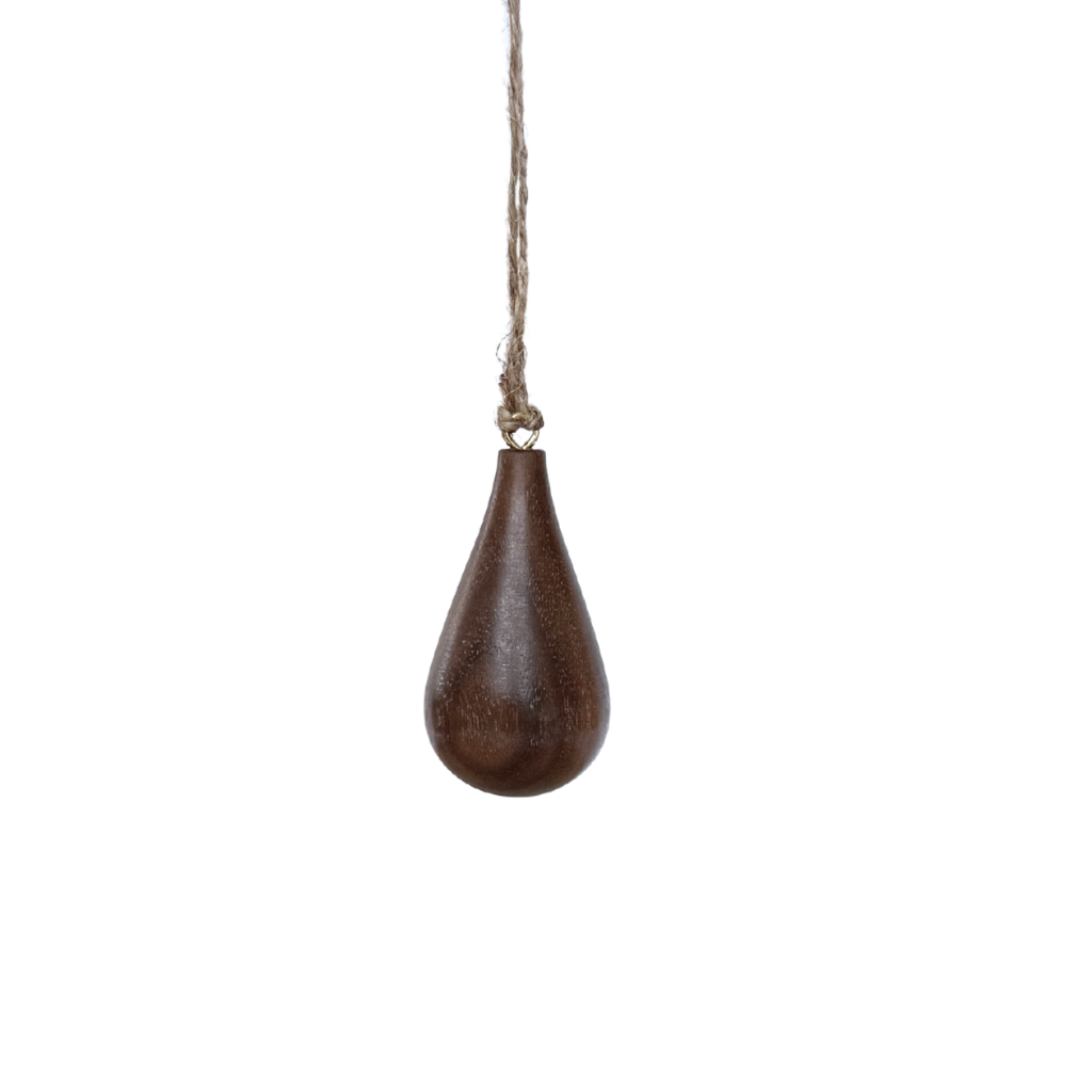Hand turned walnut timber ornament in teardrop shape with jute loop. Pebble Studio sustainable Christmas decor