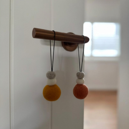 Decorative wool diffusers on a white door