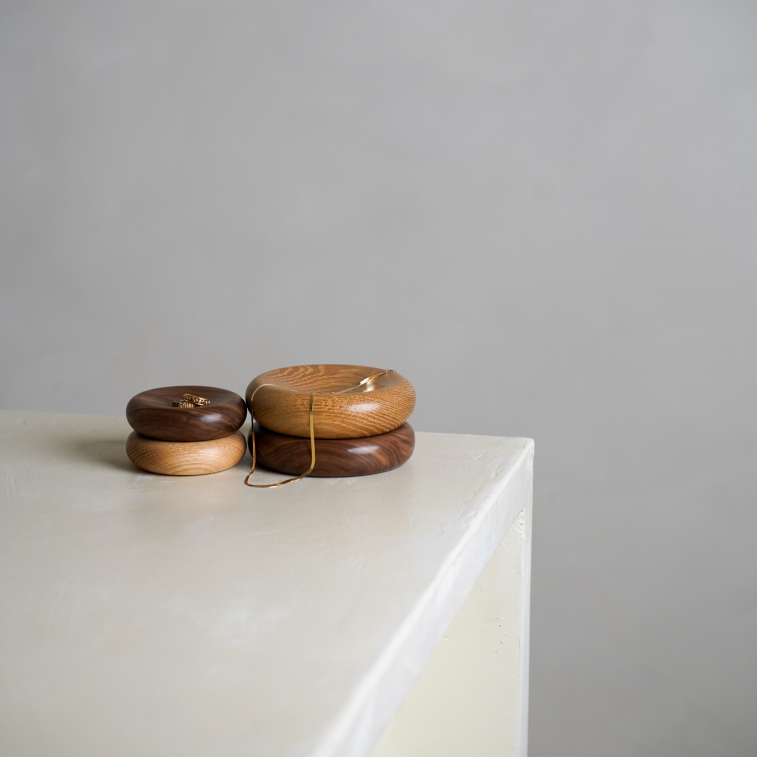 Four wood decorative pillows in small and medium sizes. The bowls are made from oak and walnut