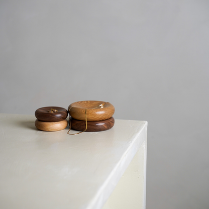 Four wood decorative pillows in small and medium sizes. The bowls are made from oak and walnut