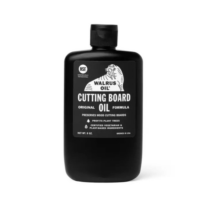 Black bottle of Walrus Oil Cutting Board Oil on a white background