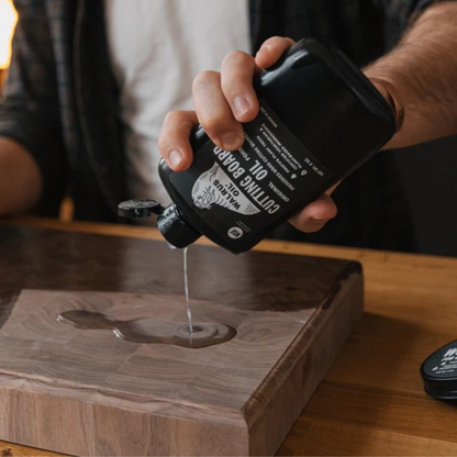 Pouring Walrus Oil on to a chopping board