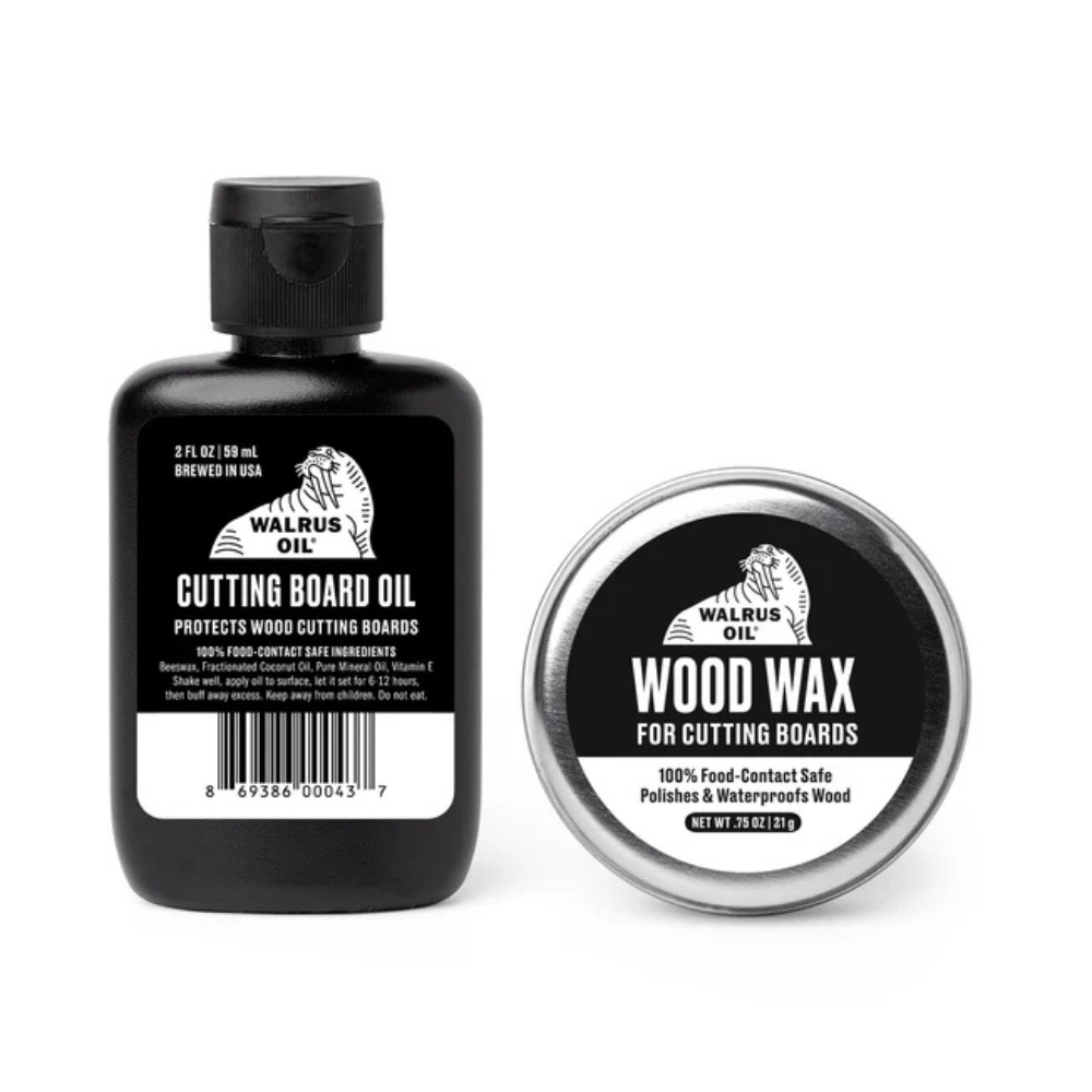 Walnut Oil Cutting Board Oil bottle and a round tin of Walnut Oil Wood Wax, both with black and white labels, on a white background.