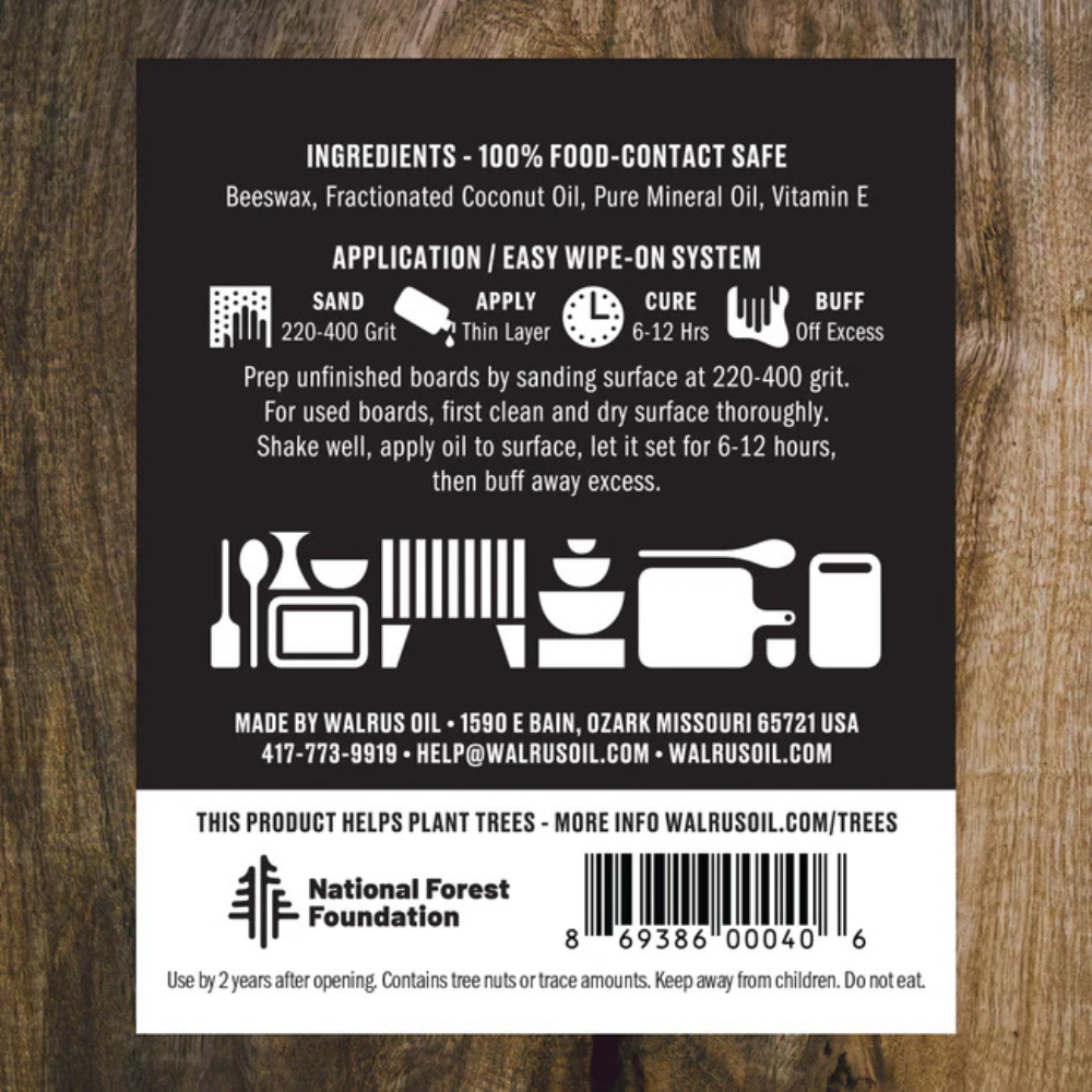 Back label of Walrus Oil- a food-safe oil with text and icons on a wooden background