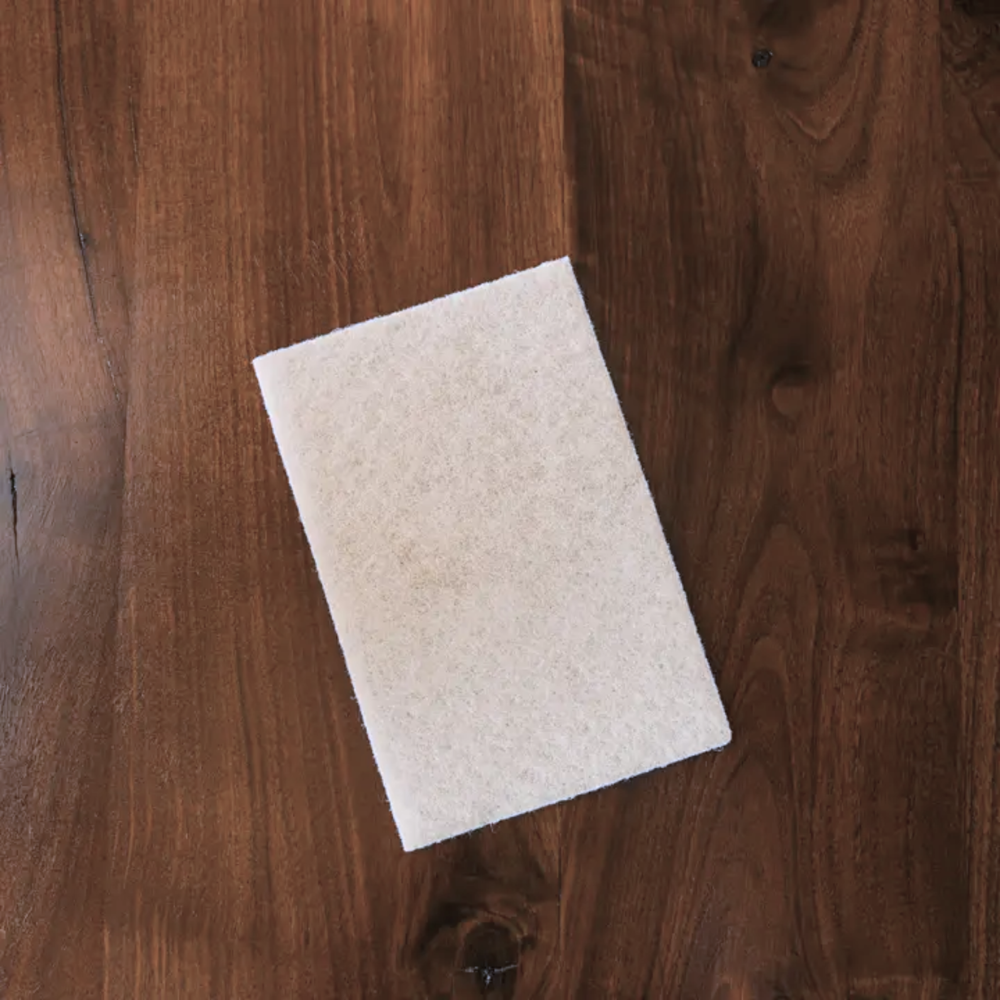 White Walrus Oil polishing pad on a wooden surface