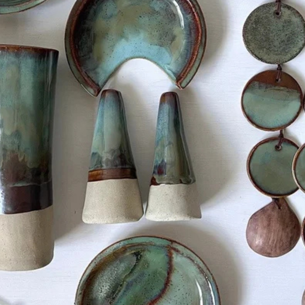 Collection of ceramic items with green and brown glaze on a white background