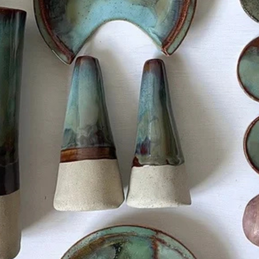 Collection of ceramic vases with textured glazes on a white surface
