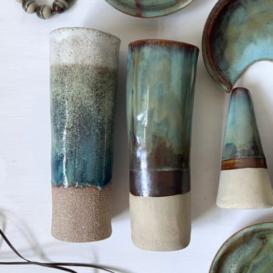 Set of ceramic vases with gradient glaze on a white surface