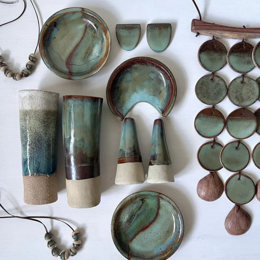 Collection of ceramic pieces with green and brown glaze on a white background