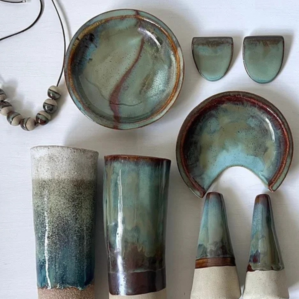 Collection of ceramic pieces with green and brown glaze on a white surface