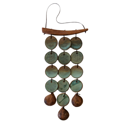Decorative wind chime with ceramic and wood discs on a white background