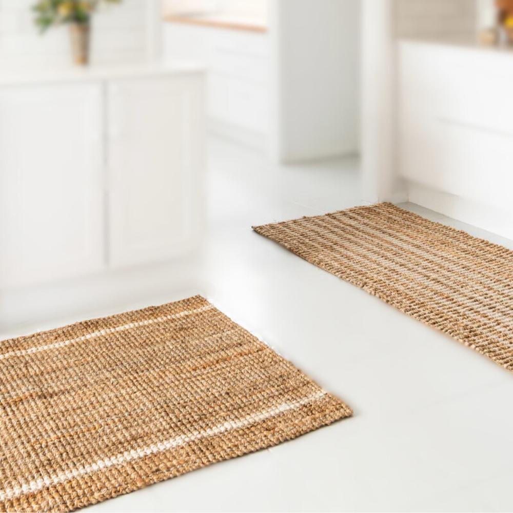 Two woven rugs on a light wooden floor with a blurred background