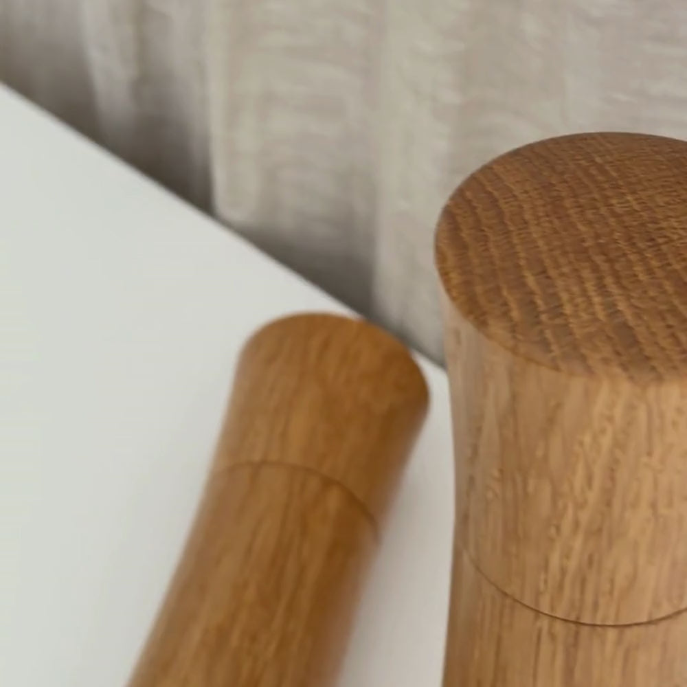 Medium and Large Pebble Studio Salt & Pepper Mill in American Oak. Minimalist design on a neutral background